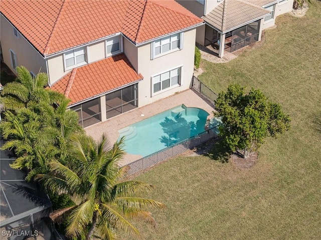 10188 Mimosa Silk Dr, Fort Myers, FL 33913 - view of swimming pool featuring a lawn, a fenced in pool, a fenced backyard, and a sunroom