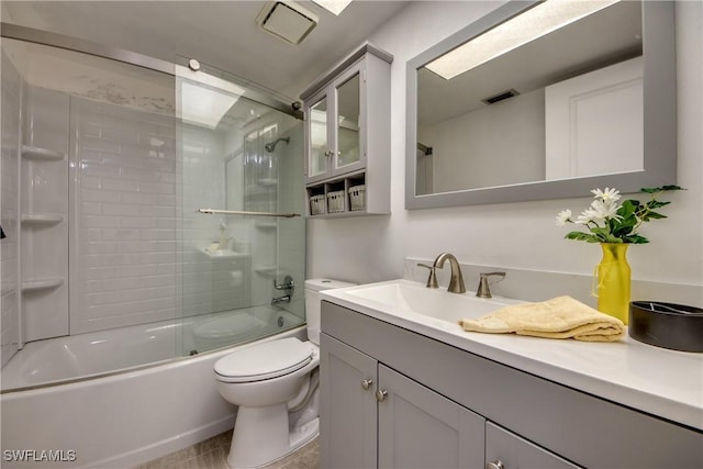 full bathroom with vanity, combined bath / shower with glass door, and toilet