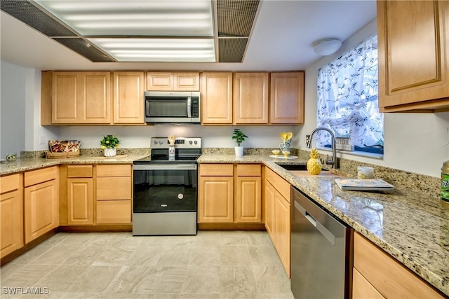 kitchen with sink, light brown cabinetry, light stone countertops, and stainless steel appliances