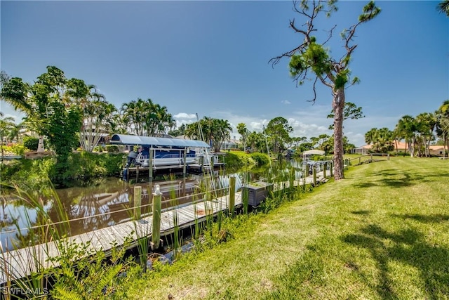 dock area with a yard and a water view