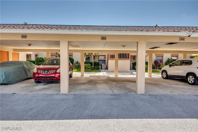 view of parking / parking lot featuring a carport