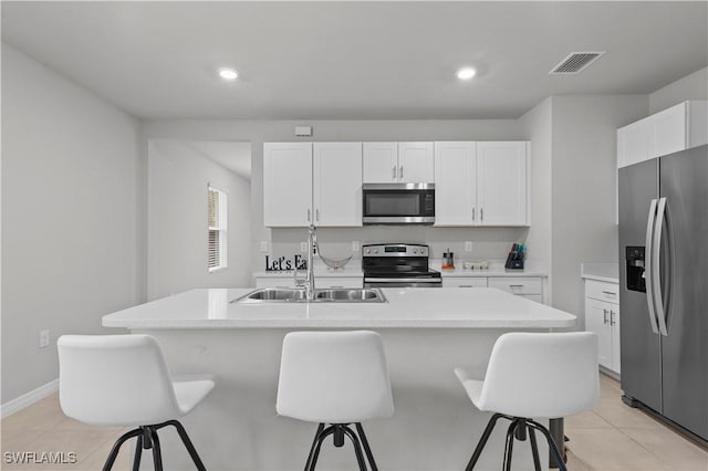 4320 Little Hickory Rd, Bonita Springs, FL 34134 - kitchen featuring stainless steel appliances, sink, an island with sink, and white cabinets