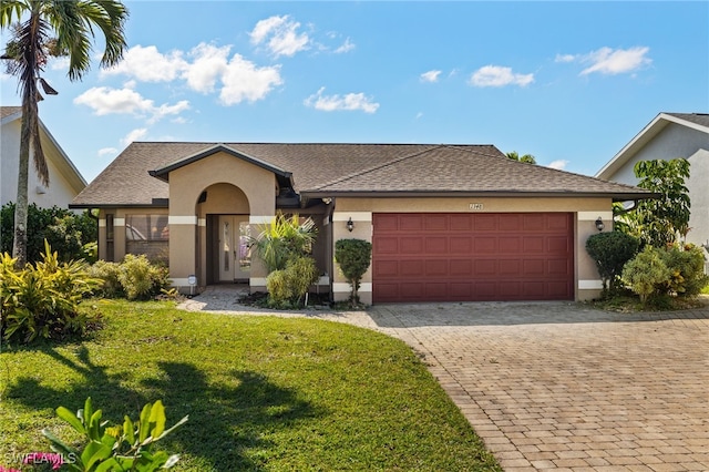 view of front facade with a garage and a front lawn