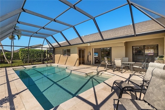 view of swimming pool featuring a lanai and a patio area