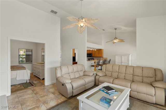 living room featuring ceiling fan and high vaulted ceiling