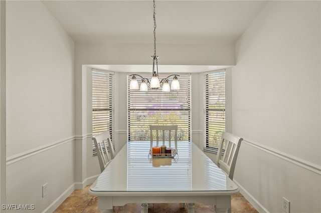 dining area featuring an inviting chandelier