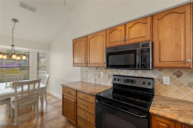 kitchen featuring decorative light fixtures, light stone countertops, vaulted ceiling, and black appliances