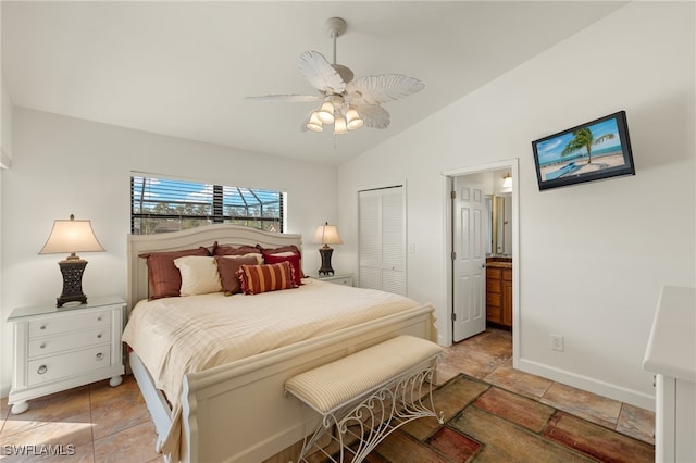 bedroom featuring ceiling fan, lofted ceiling, ensuite bathroom, and a closet