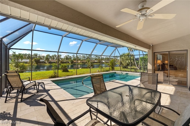 view of swimming pool featuring a patio, a water view, a yard, and a lanai