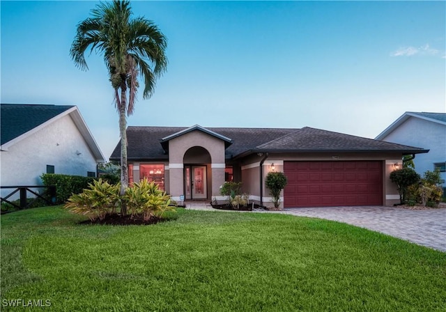 view of front of home featuring a garage and a front lawn