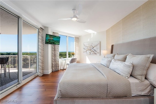 bedroom featuring hardwood / wood-style flooring, access to outside, and ceiling fan