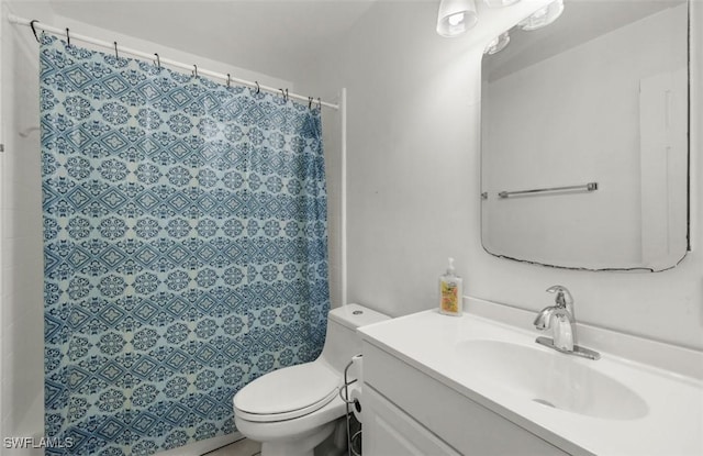 bathroom with vanity, toilet, and walk in shower