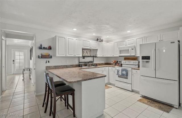 kitchen with sink, white cabinets, light tile patterned floors, kitchen peninsula, and white appliances