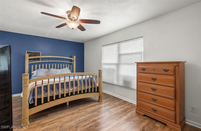 bedroom with wood-type flooring and ceiling fan