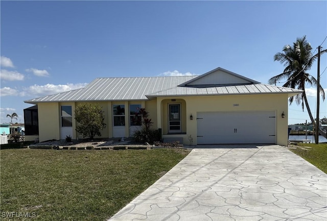 ranch-style home featuring a water view, a garage, and a front yard