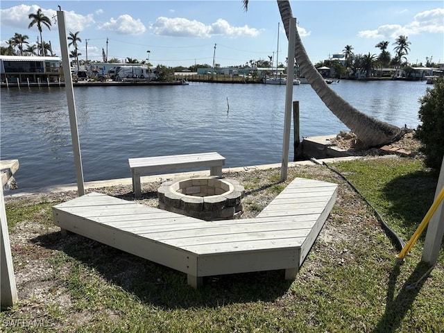 view of dock with a water view and an outdoor fire pit