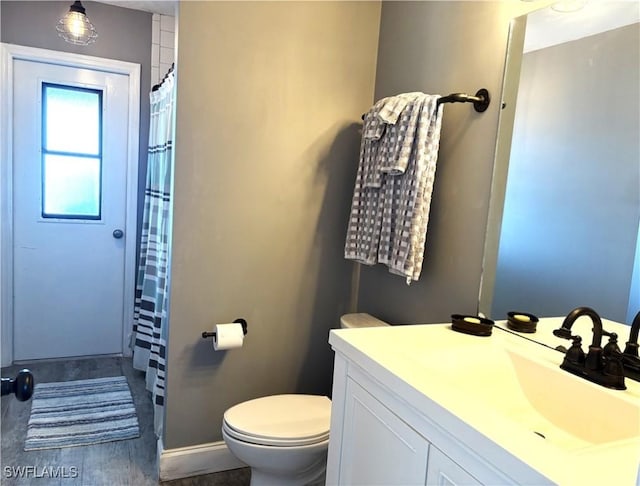 bathroom with vanity, toilet, and a shower with shower curtain