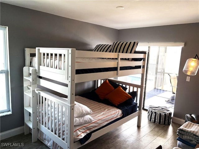 bedroom featuring dark wood-type flooring and multiple windows