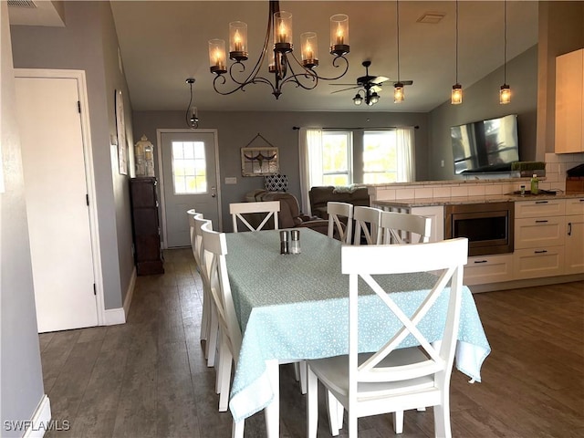 dining room with lofted ceiling and dark hardwood / wood-style floors