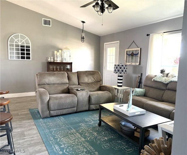 living room featuring lofted ceiling, hardwood / wood-style floors, and ceiling fan