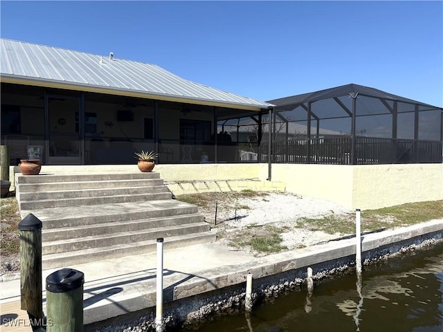 dock area with a water view and a lanai