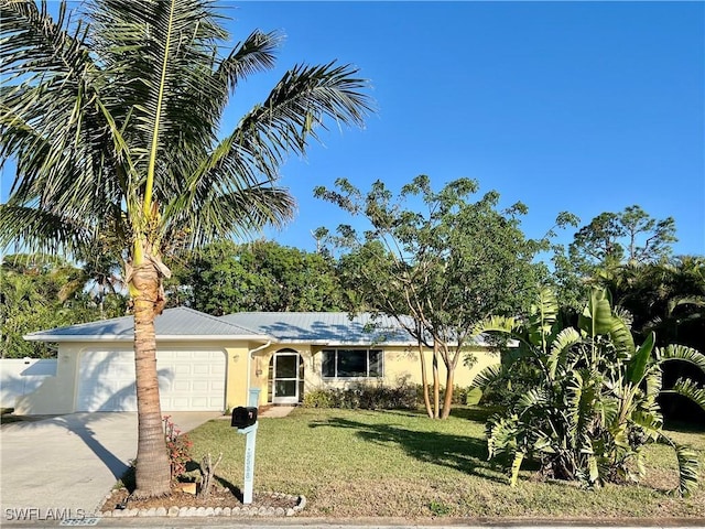 single story home featuring a garage and a front lawn