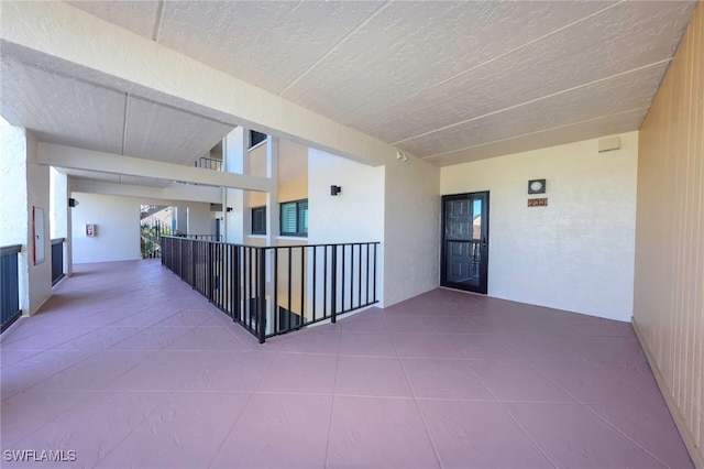 interior space featuring a textured ceiling and tile patterned floors