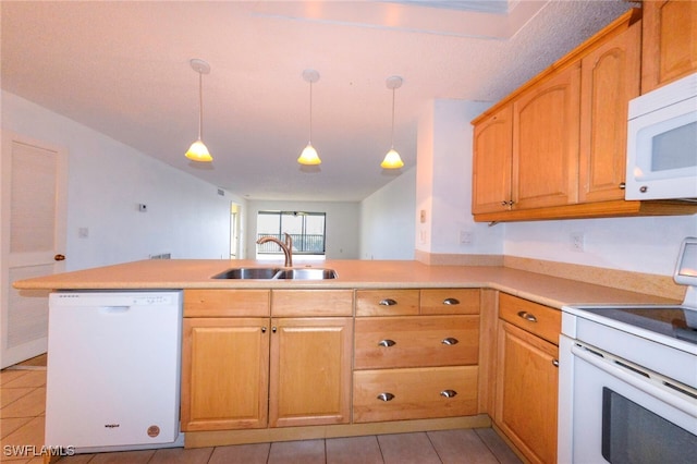 kitchen featuring hanging light fixtures, white appliances, light tile patterned floors, sink, and kitchen peninsula