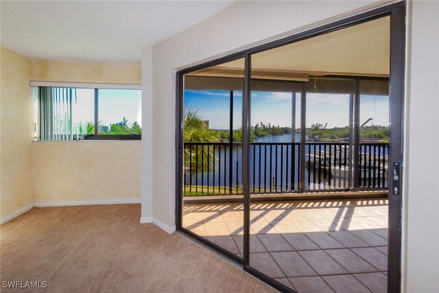 interior space with a water view and a healthy amount of sunlight