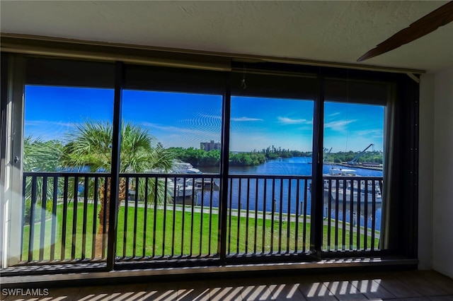 unfurnished sunroom with a water view