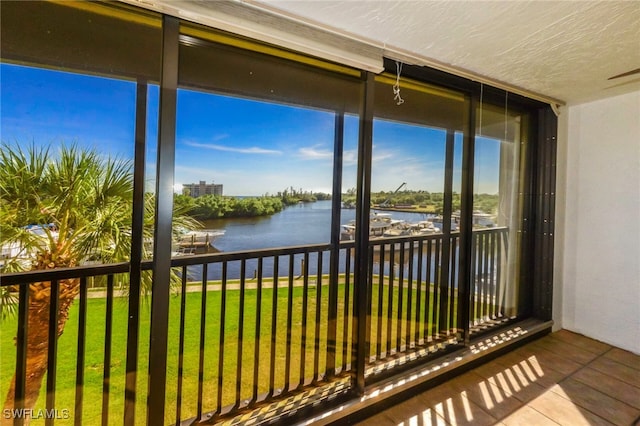 unfurnished sunroom featuring a water view