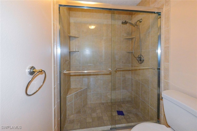 bathroom with toilet and walk in shower