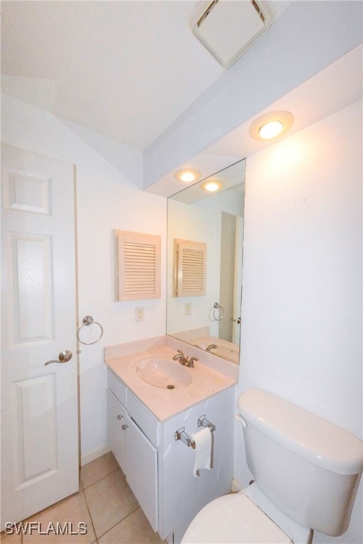 bathroom with tile patterned floors, vanity, and toilet