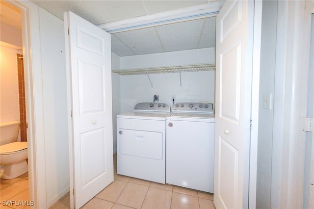 laundry room with light tile patterned floors and separate washer and dryer