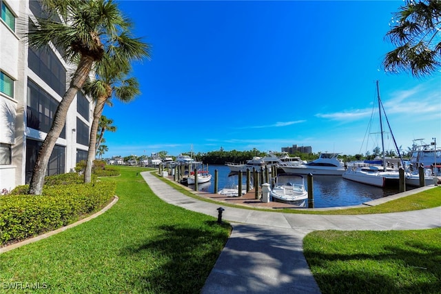 exterior space featuring a lawn and a water view