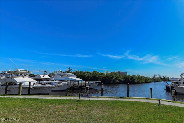 dock area featuring a lawn and a water view