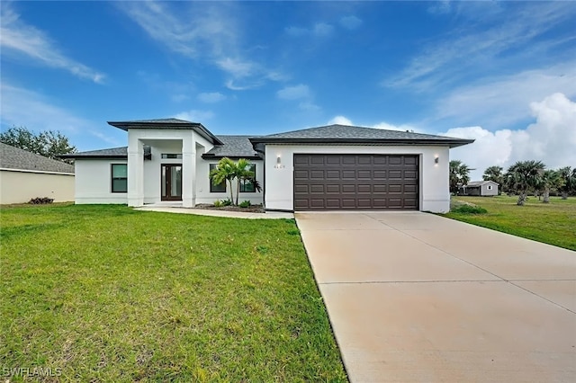 view of front of home featuring a garage and a front lawn