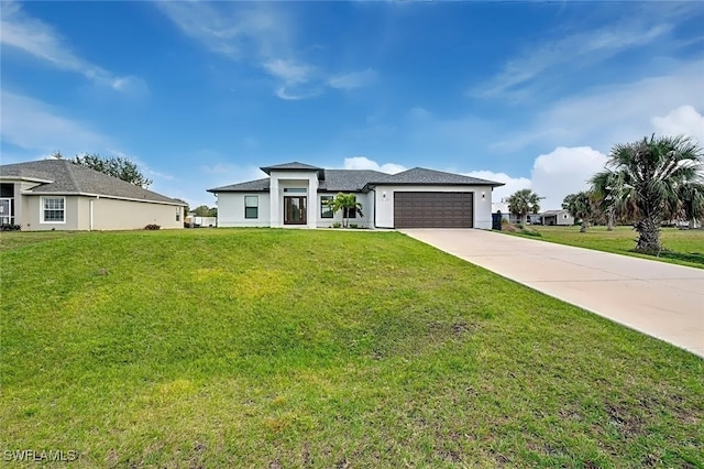 view of front of property featuring a garage and a front lawn