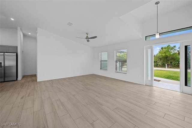 unfurnished living room with lofted ceiling, light wood-type flooring, and ceiling fan