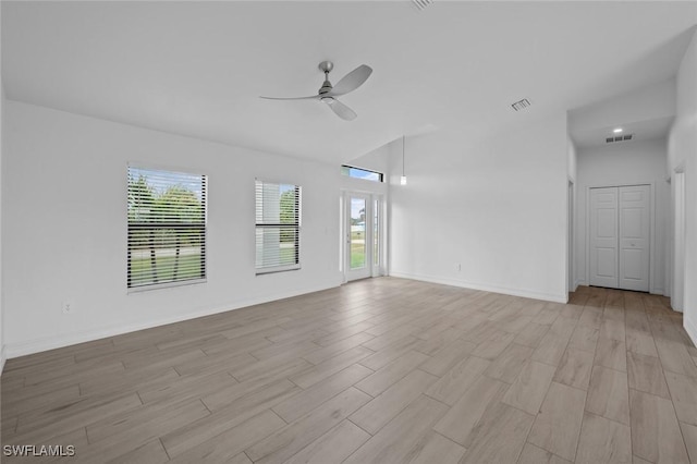 spare room with light hardwood / wood-style flooring, ceiling fan, and vaulted ceiling