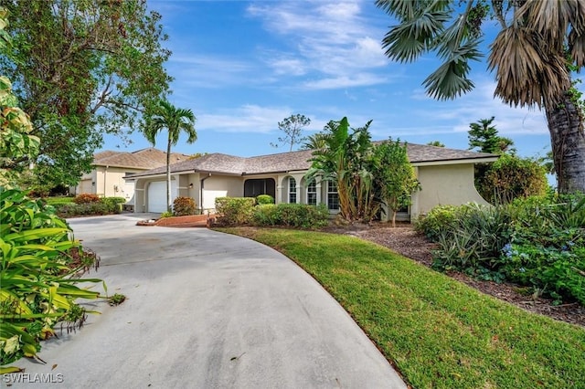 ranch-style home with a garage and a front lawn