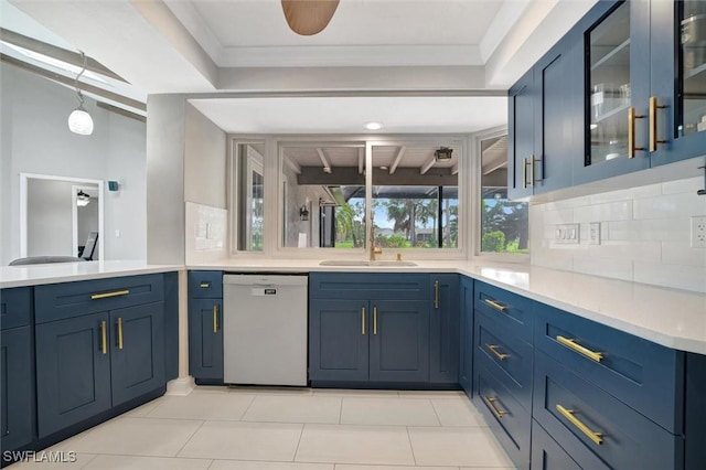 kitchen with blue cabinets, dishwasher, sink, and decorative backsplash