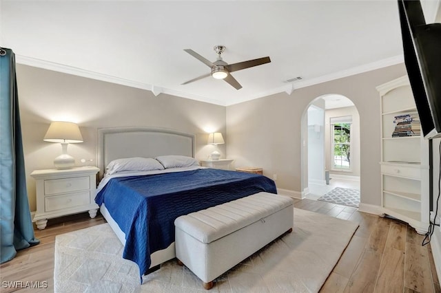 bedroom featuring ceiling fan, ornamental molding, and light hardwood / wood-style flooring