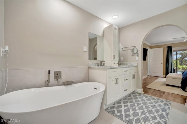 bathroom featuring vanity and a washtub