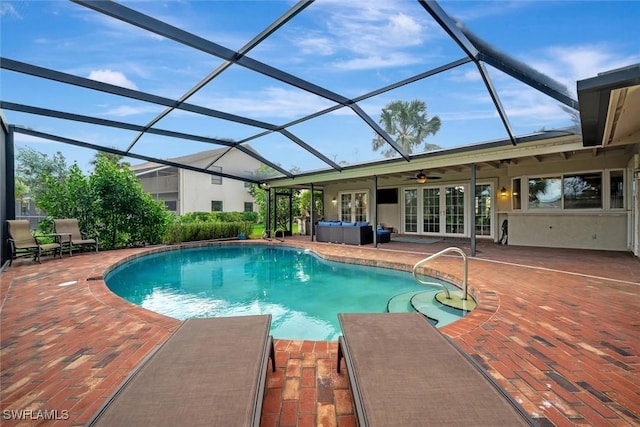 view of swimming pool featuring a patio, a lanai, ceiling fan, an outdoor living space, and french doors