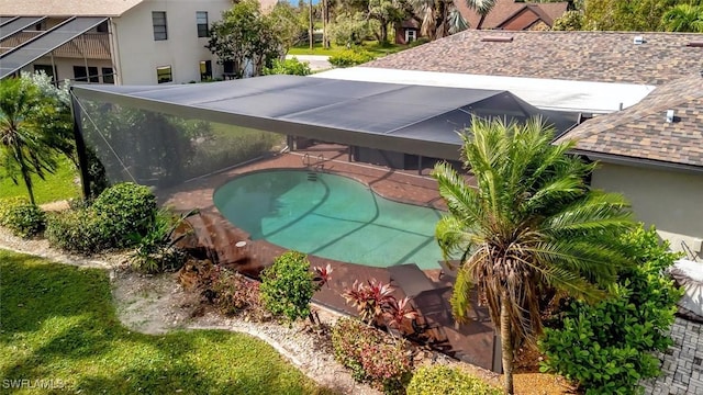 view of swimming pool with glass enclosure