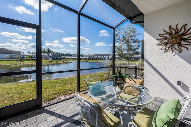 sunroom / solarium with a water view