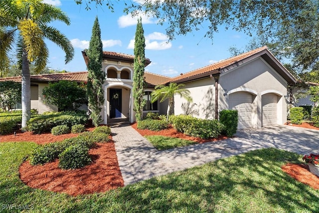 mediterranean / spanish home with a garage