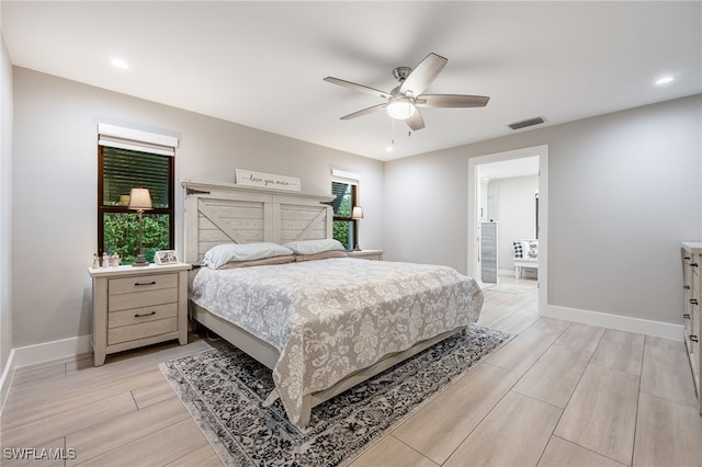 bedroom with wood finish floors, visible vents, ceiling fan, and baseboards