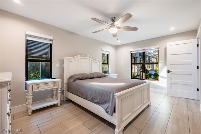 bedroom featuring recessed lighting, wood tiled floor, a ceiling fan, and baseboards